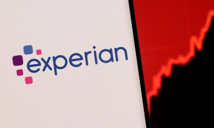 Experian logo is seen on a smartphone in front of displayed stock graph in this illustration taken on Dec. 1, 2021. (Dado Ruvic/Reuters)
