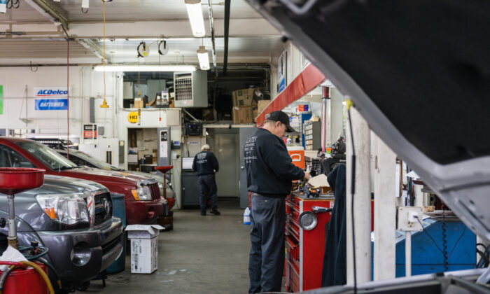 An auto mechanic stands at a workbench at an automotive service in Louisville, Kentucky on Jan. 13, 2022. (Jon Cherry/Getty Images)