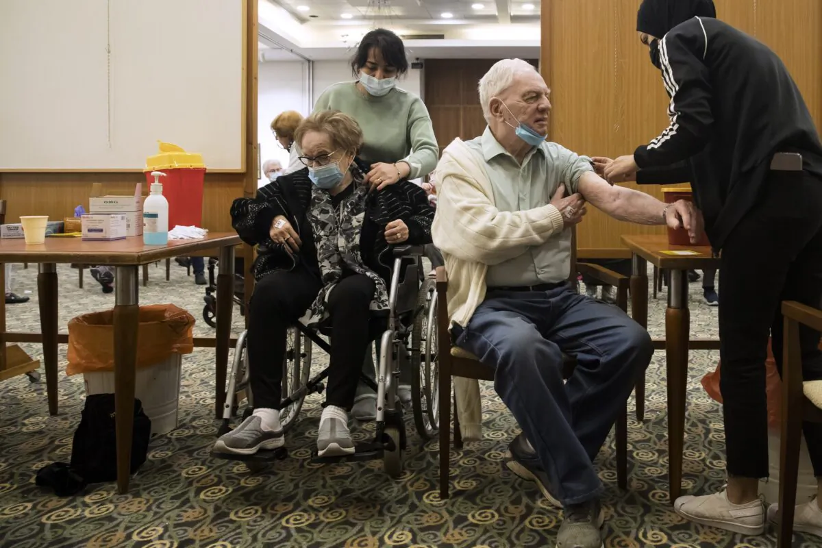 Local residents receive a fourth dose of the coronavirus vaccine at a nursing home, after Israel approved it for people over 60, in Tel Mond, Israel, on Jan. 6, 2022. (Amir Levy/Getty Images)