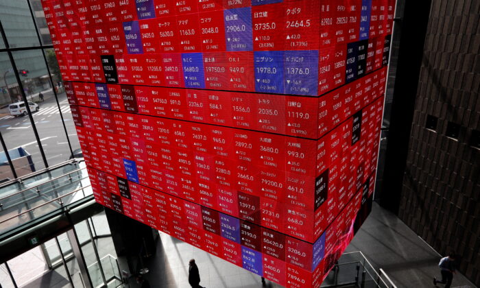 An electronic stock quotation board is displayed inside a conference hall in Tokyo on Nov. 1, 2021. (Issei Kato/Reuters)
