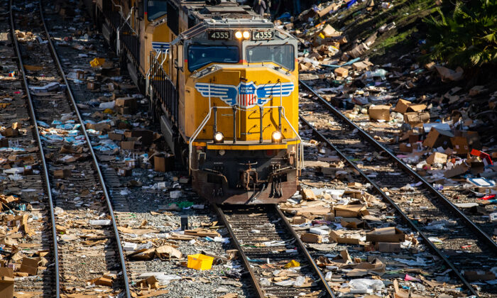 Empty boxes lie scattered near the railroad tracks after ongoing train robberies in the Lincoln Heights neighborhood of Los Angeles on Jan. 14, 2022. (John Fredricks/The Epoch Times)