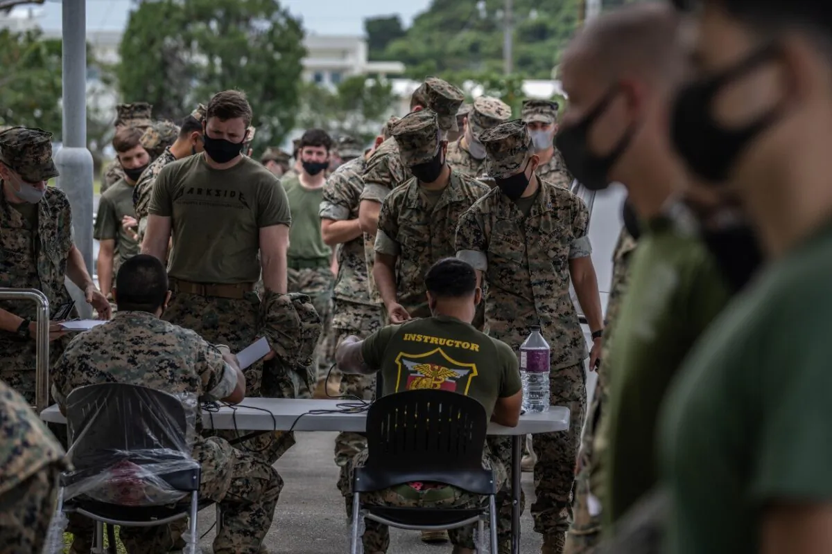 United States Marines queue to receive the Moderna coronavirus vaccine at Camp Hansen on April 28, 2021 in Kin, Japan. (Carl Court/Getty Images)