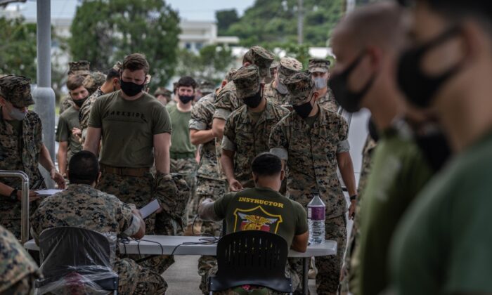 United States Marines queue to receive the Moderna coronavirus vaccine at Camp Hansen on April 28, 2021 in Kin, Japan. (Carl Court/Getty Images)