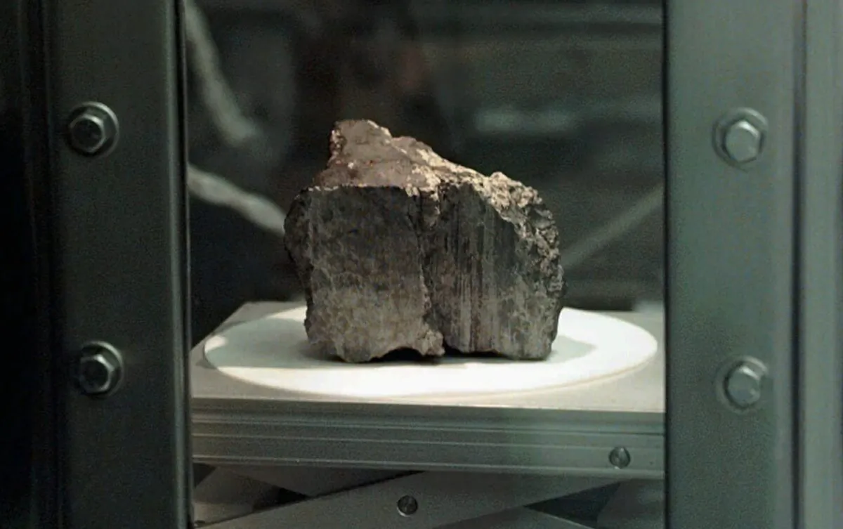 The meteorite labeled ALH84001 sits in a chamber at a Johnson Space Center lab in Houston, on Aug. 7, 1996. (David J. Phillip/AP Photo)