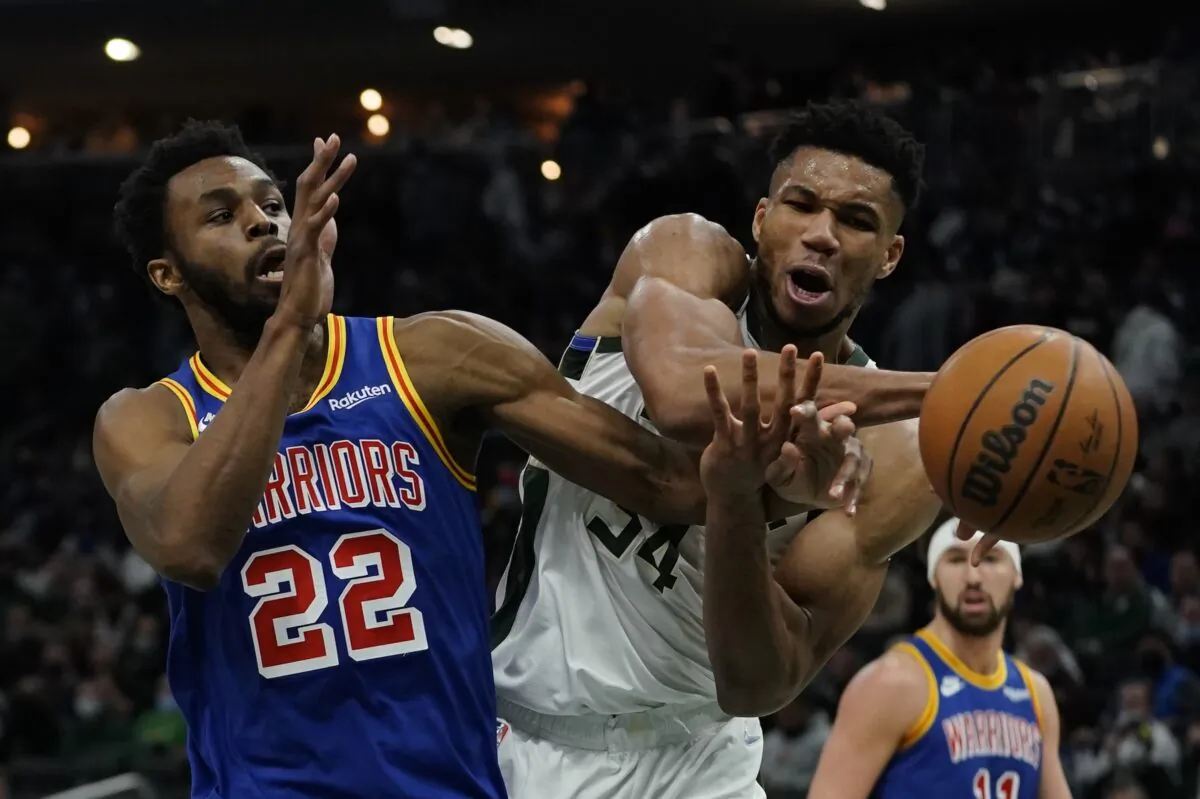 Milwaukee Bucks' Giannis Antetokounmpo is fouled by Golden State Warriors' Andrew Wiggins during the second half of an NBA basketball game in Milwaukee, on Jan. 13, 2022. (Morry Gash/AP Photo)
