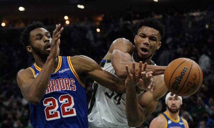 Milwaukee Bucks' Giannis Antetokounmpo is fouled by Golden State Warriors' Andrew Wiggins during the second half of an NBA basketball game in Milwaukee, on Jan. 13, 2022. (Morry Gash/AP Photo)