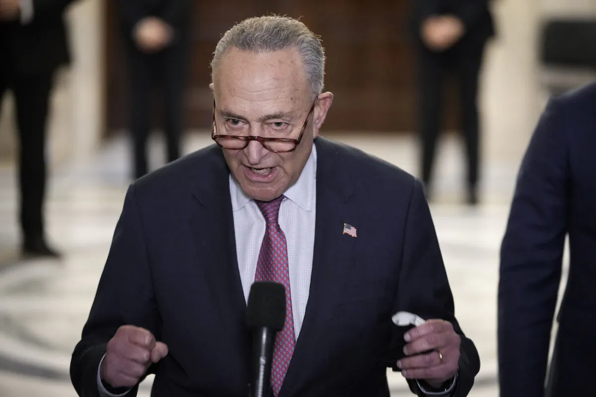 Senate Majority Leader Chuck Schumer (D-N.Y.) speaks to reporters after a meeting with U.S. President Joe Biden and Senate Democrats in the Russell Senate Office Building on Capitol Hill in Washington, on Jan. 13, 2022. (Drew Angerer/Getty Images)