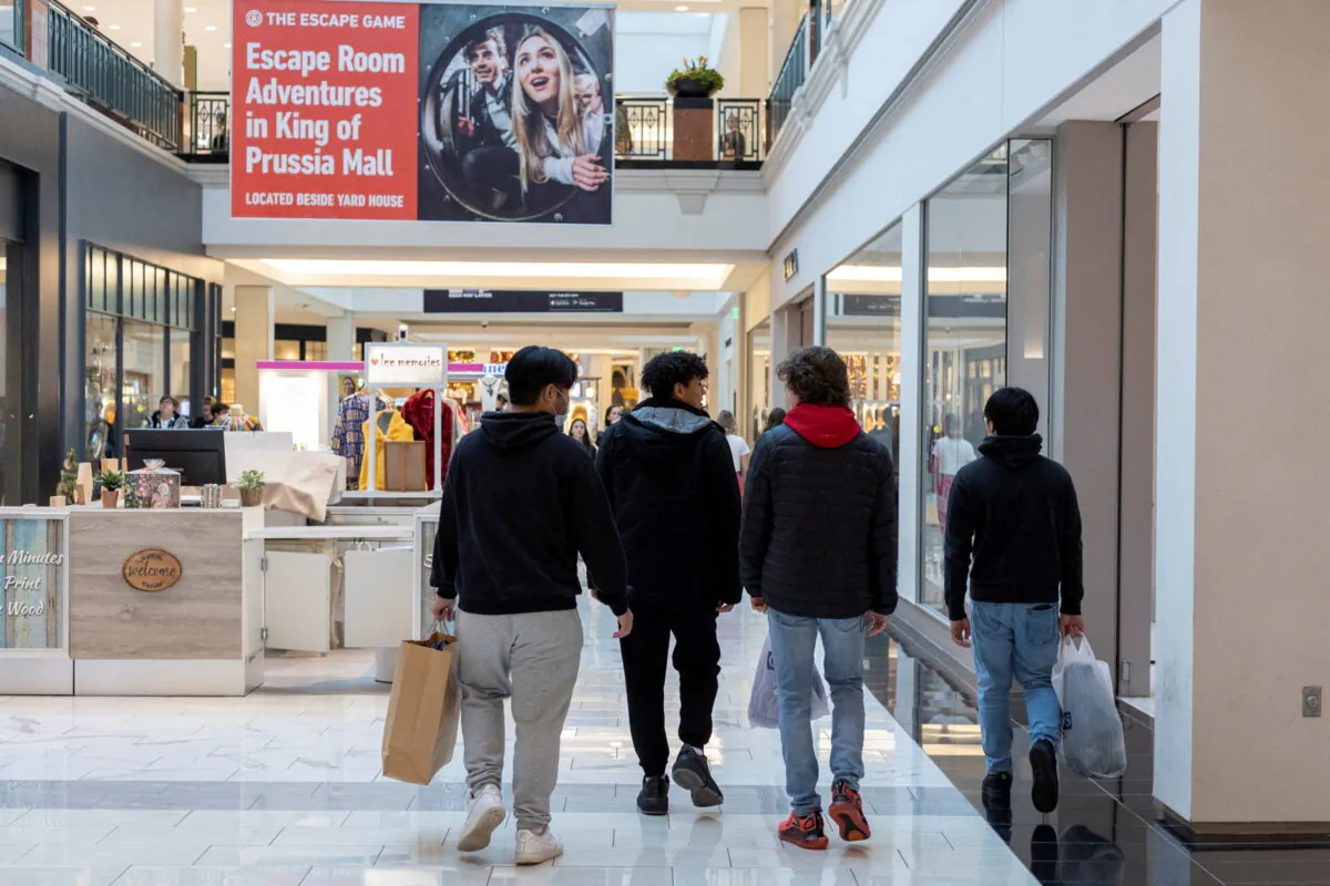 People carrying shopping bags walk inside the King of Prussia shopping mall, as shoppers show up early for the Black Friday sales, in King of Prussia, Pa., on Nov. 26, 2021. (Rachel Wisniewski/File Photo/Reuters)
