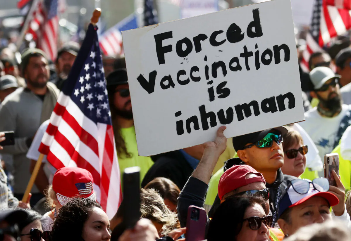 Protesters gather in Grand Park outside City Hall at a March for Freedom rally demonstrating against the Los Angeles City Council’s COVID-19 vaccine mandate for city employees and contractors, in Los Angeles on Nov. 8, 2021. (Mario Tama/Getty Images)