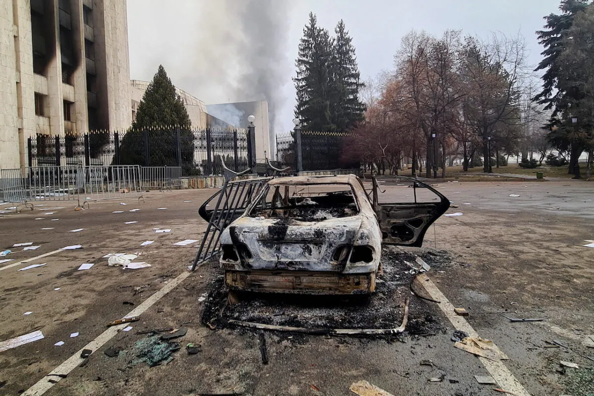 A burnt vehicle near the mayor's office building following the protests triggered by fuel price increase, in Almaty, Kazakhstan, on Jan. 6, 2022. (Mariya Gordeyeva/Reuters)