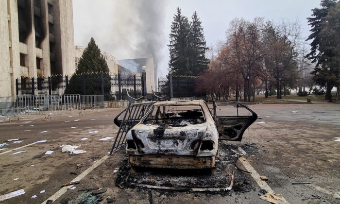 A burnt vehicle near the mayor's office building following the protests triggered by fuel price increase, in Almaty, Kazakhstan, on Jan. 6, 2022. (Mariya Gordeyeva/Reuters)