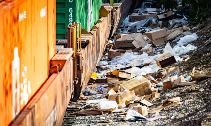Cardboard boxes lay strewn across railroad tracks three miles from downtown Los Angeles on Jan. 14, 2022. (John Fredricks/The Epoch Times)