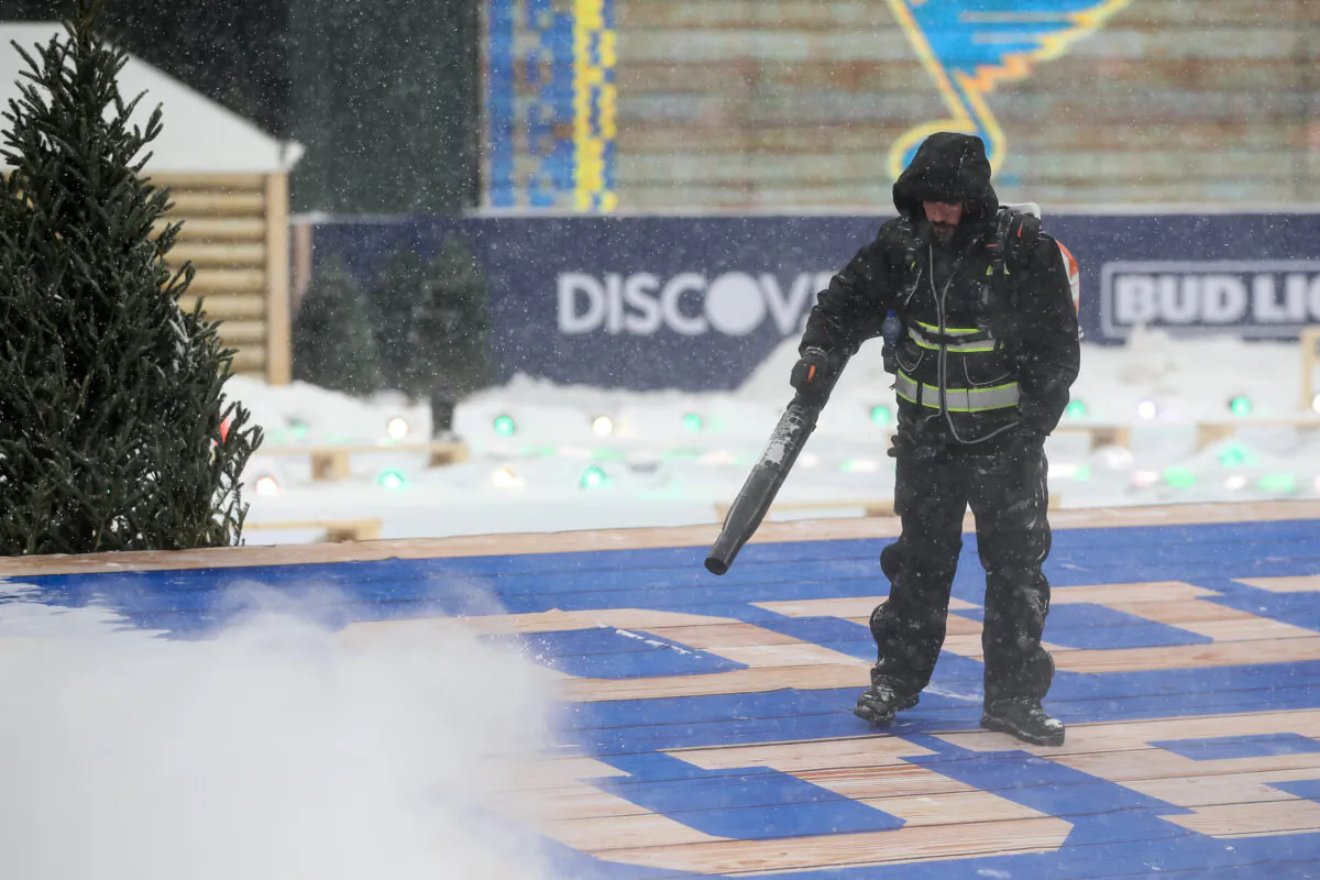 A worker clears snow in Minneapolis, on Dec. 31, 2021. (David Berding/Getty Images)