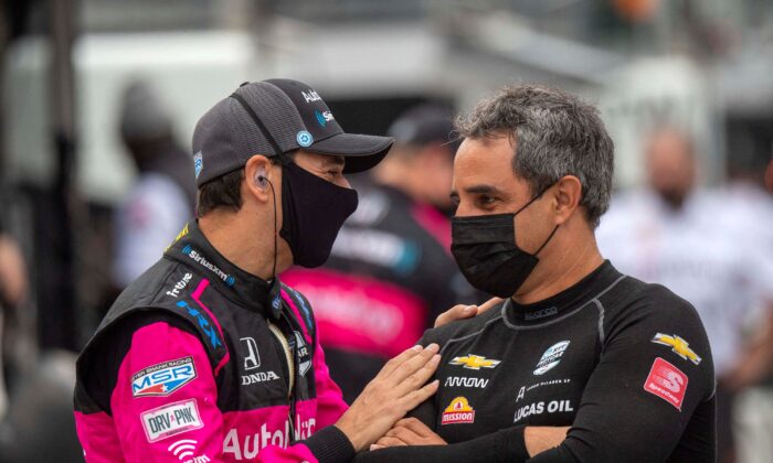 Schmidt Peterson Motorsports driver Robert Wickens (6) (L) shares a moment with Arrow McLaren SP driver and two time Indy 500 winner Juan Pablo Montoya (86) before practice begins at Indianapolis Motor Speedway in Indianapolis, on May 18, 2021. (Marc Lebryk/USA TODAY Sports via Reuters)