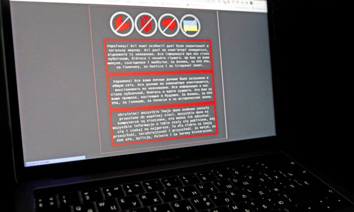 A laptop screen displays a warning message in Ukrainian, Russian, and Polish, that appeared on the official website of the Ukrainian Foreign Ministry after a massive cyberattack, in this illustration taken on Jan. 14, 2022. (Valentyn Ogirenko/Illustration/Reuters)