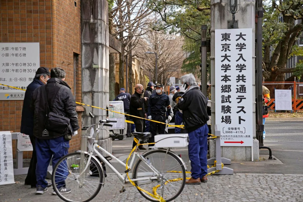 Police officers inspect the site of a stabbing near the compound of Tokyo University in Tokyo, Japan, on Jan. 15, 2022. (Ren Onuma/Kyodo News via AP)
