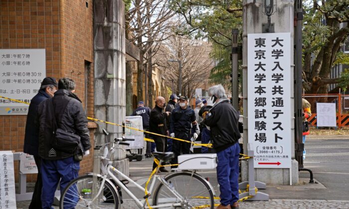 Police officers inspect the site of a stabbing near the compound of Tokyo University in Tokyo, Japan, on Jan. 15, 2022. (Ren Onuma/Kyodo News via AP)