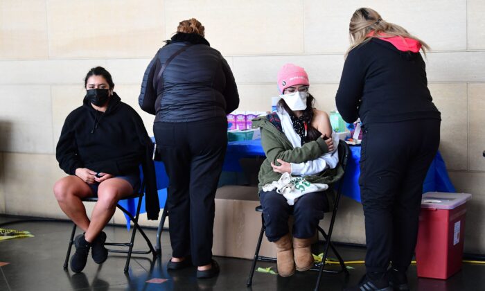 People receive a COVID-19 vaccination at Union Station in Los Angeles on Jan. 7, 2022. (Frederic J. Brown/AFP via Getty Images)