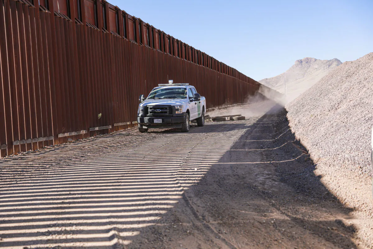A Border Patrol agent pulls tires behind his vehicle to smooth out the road to make detecting footprints easier, near Naco in Cochise County, Arizona on Dec. 6, 2021. (Charlotte Cuthbertson/The Epoch Times)