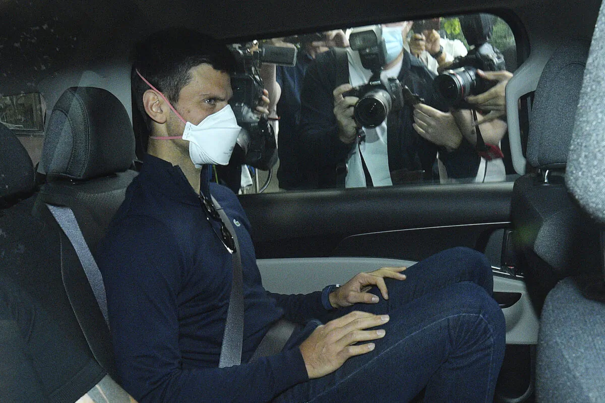 Serbian tennis player Novak Djokovic rides in car as he leaves a government detention facility before attending a court hearing at his lawyers office in Melbourne, Australia, on Jan. 16, 2022. (James Ross/AAP via AP)