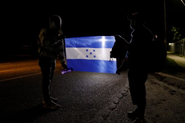 Migrants holding a Honduran national flag