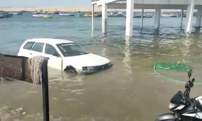 A flooded car in Pisco, Peru, on Jan. 15, 2022, in a still from a video. (Pisco te informa via Reuters/Screenshot via The Epoch Times) 