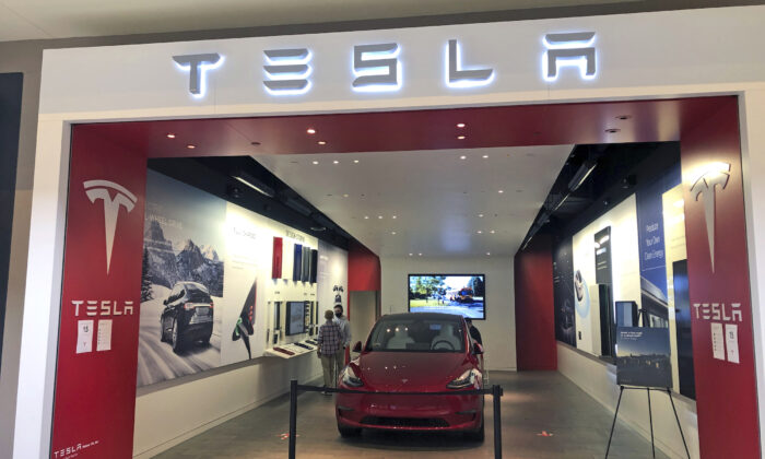A Tesla car dealership store is in Ross Park Mall in Ross Township, Pa., on March 16, 2021. (Ted Shaffrey/AP Photo)
