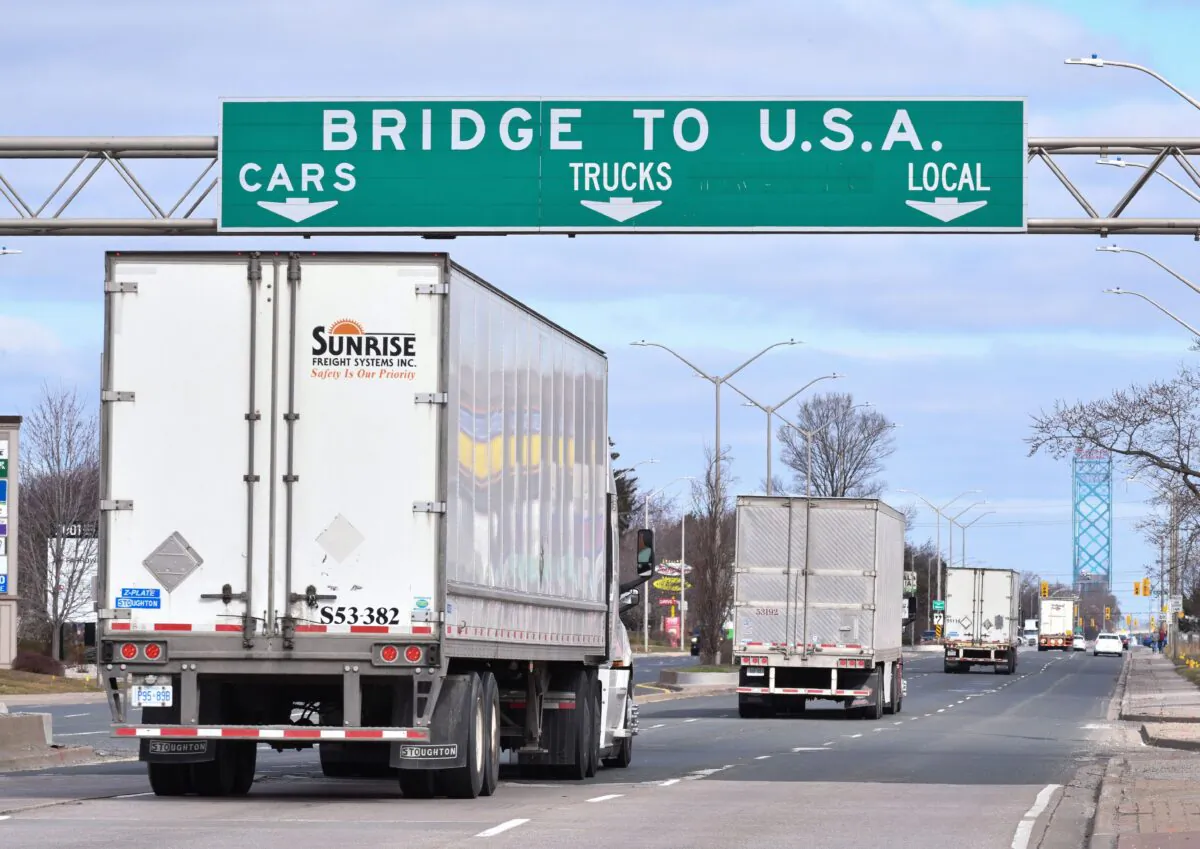 Transport trucks approach the Canada–U.S. border crossing in Windsor, Ont., on March 21, 2020. (The Canadian Press/Rob Gurdebeke)