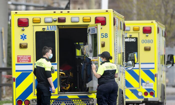 Paramedics prepare to transfer a patient to a hospital in Montreal in a file photo. (The Canadian Press/Graham Hughes)