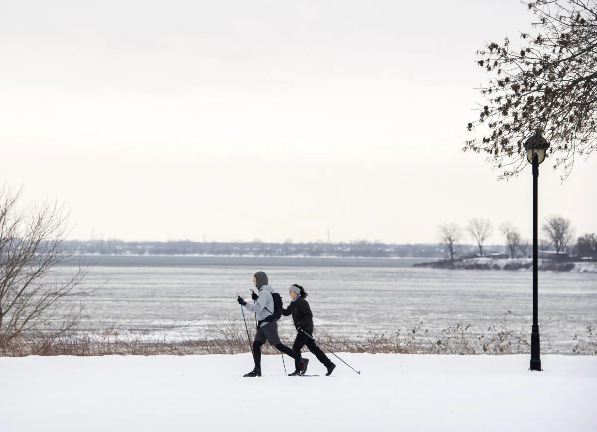 People are shown cross country skiing next to the St. Lawerence River in Montreal, Jan. 9, 2022. (The Canadian PressS/Graham Hughes)