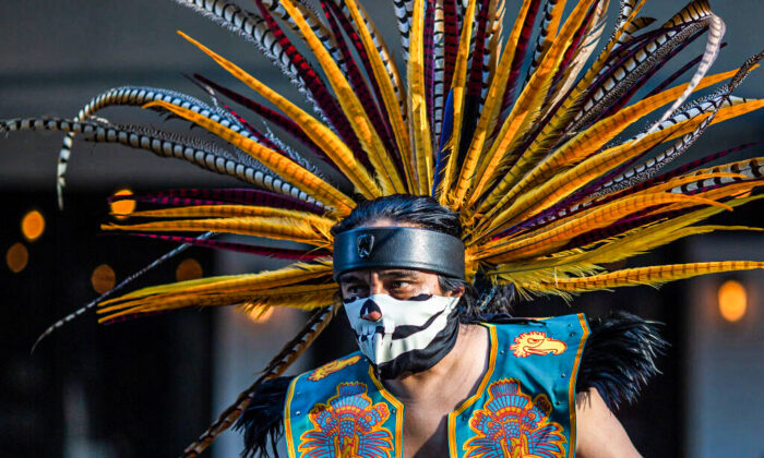 An Aztec dancer participates in a march in Los Angeles, on May 1, 2019. David McNew/Getty Images