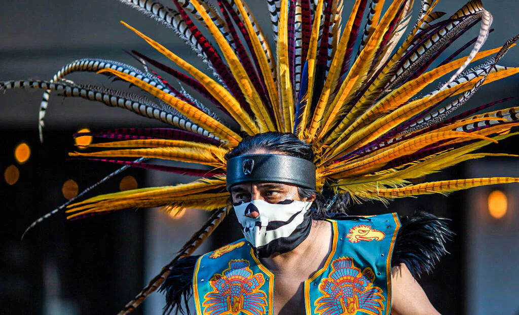 An Aztec dancer participates in a march in Los Angeles, on May 1, 2019. David McNew/Getty Images