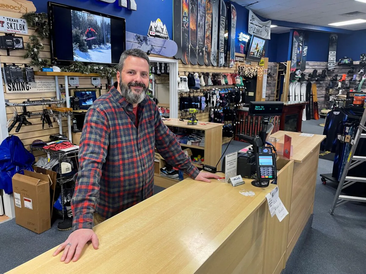 Phillip Howard poses for a photo inside his Troy's Ski Lubbock shop, in Lubbock, Texas, on Jan. 14, 2022. (Brad Brooks/Reuters)
