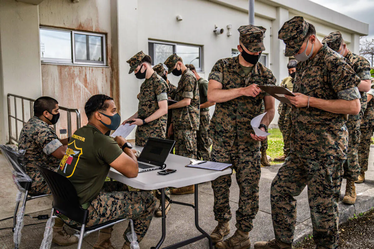 United States Marines register their details as they queue to receive the Moderna COVID-19 vaccine at Camp Hansen in Kin, Japan, on April 28, 2021. (Carl Court/Getty Images)