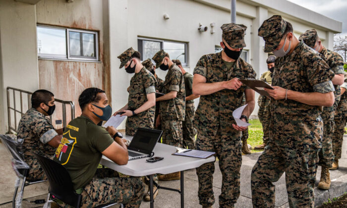 United States Marines register their details as they queue to receive the Moderna COVID-19 vaccine at Camp Hansen in Kin, Japan, on April 28, 2021.  (Carl Court/Getty Images)