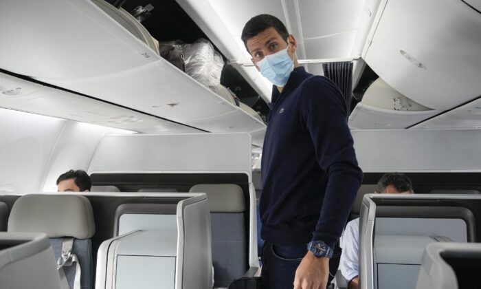 Novak Djokovic prepares to take his seat on a plane to Belgrade, in Dubai, United Arab Emirates, on Jan. 17, 2022. (Darko Bandic/AP Photo)