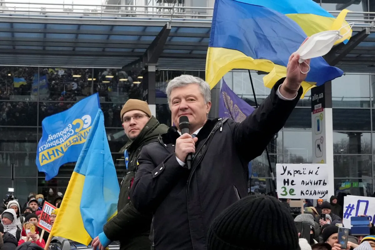 Former Ukrainian President Petro Poroshenko gestures while speaking to his supporters upon his arrival at Zhuliany International Airport outside Kyiv, Ukraine, on Jan. 17, 2022.  (Efrem Lukatsky/AP Photo)