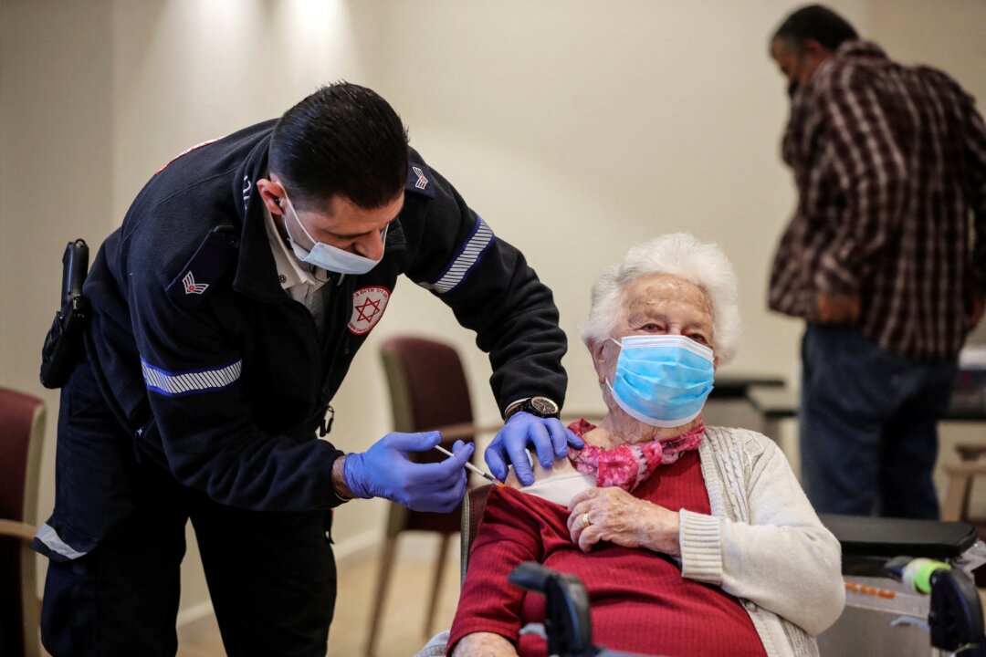 A woman receives a second Pfizer COVID-19 vaccine booster shot in Netanya, Israel on Jan. 5, 2022. (Ammar Awad)