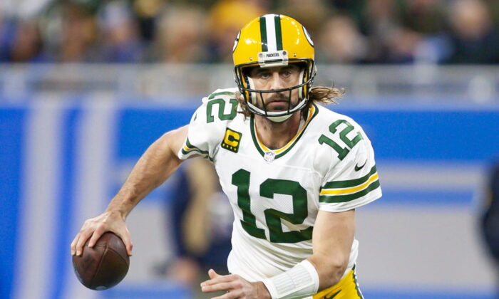 Green Bay Packers quarterback Aaron Rodgers (12) runs the ball during the first quarter against the Detroit Lions at Ford Field in Detroit, Mich., on Jan 9, 2022. (Raj Mehta-USA TODAY Sports)