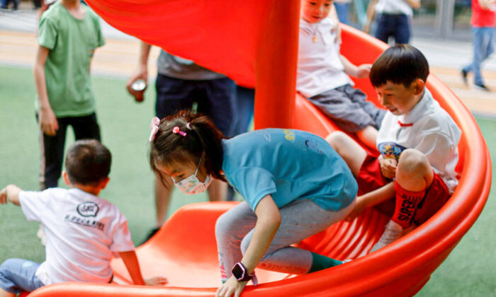 Children play at a playground inside a shopping complex in Shanghai on June 1, 2021. (Aly Song/Reuters)