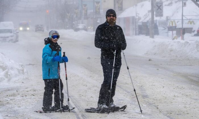 ONT Winter Weather 20220117
Snowshoers pause on a major road artery during a severe winter storm in Toronto on January 17, 2022. (The Canadian Press/Frank Gunn)