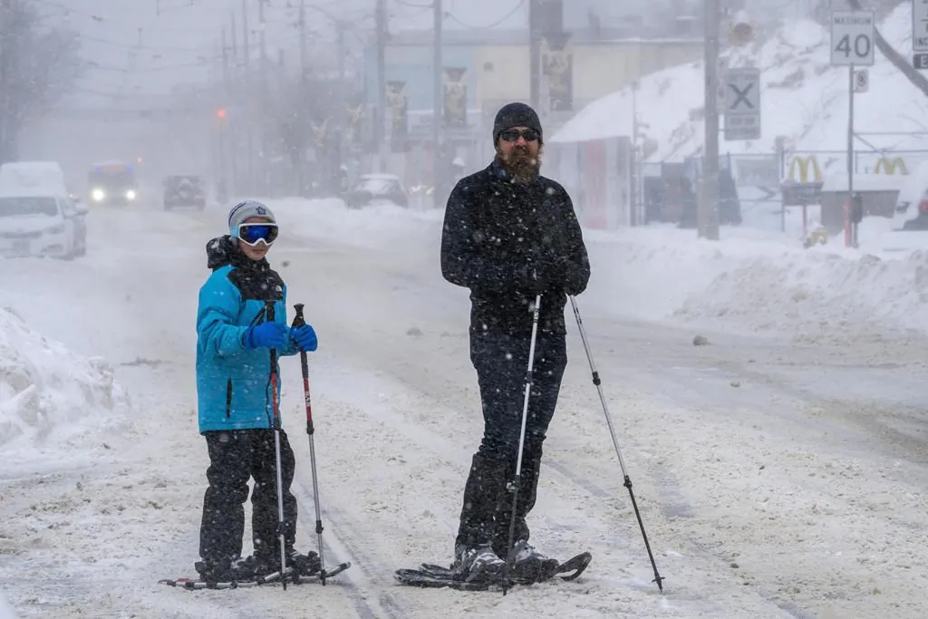 ONT Winter Weather 20220117
Snowshoers pause on a major road artery during a severe winter storm in Toronto on January 17, 2022. (The Canadian Press/Frank Gunn)