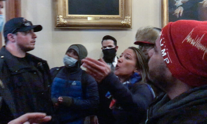 Moments before being shot to death, Ashli Babbitt confronts three police offers for not stopping the vandalism outside the U.S. House. (Video Still / ©Tayler Hansen)