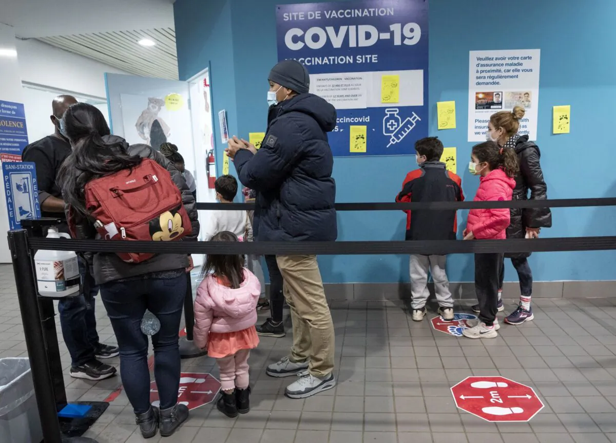 People line up to get their children vaccinated at a clinic in Montreal on Nov. 25, 2021. (Ryan Remiorz/The Canadian Press)
