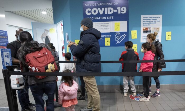 People line up to get their children vaccinated at a clinic in Montreal on Nov. 25, 2021. (Ryan Remiorz/The Canadian Press)