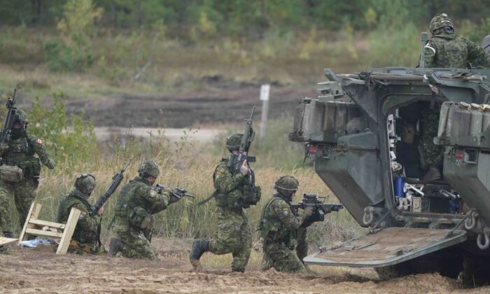 Canadian soldiers attend the NATO military exercises ''Namejs 2021'' at a training ground in Kadaga, Latvia, on Monday, Sept. 13, 2021. (AP/Roman Koksarov) 
