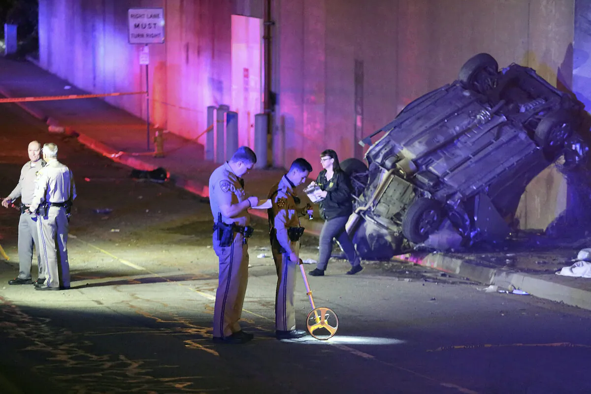 California Highway Patrol officers work at the scene of a fatal accident after the vehicle plunged off an elevated section of Interstate 210 landing below on Michillinda Ave., in Pasadena, Calif., on Jan. 16, 2022. (James Carbone/AP Photo)