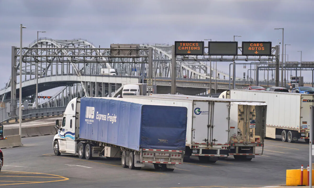 Trucks wait to cross the Bluewater Bridge border crossing from Sarnia, Ontario to Port Huron Michigan on March 16, 2020. (Geoff Robins/AFP via Getty Images)