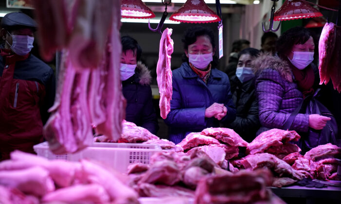 Residents buy pork to make sausage for the upcoming Chinese Spring Festival on a street famous for its sausages in Wuhan, Hubei Province, China, on Dec. 31, 2020. (Getty Images)