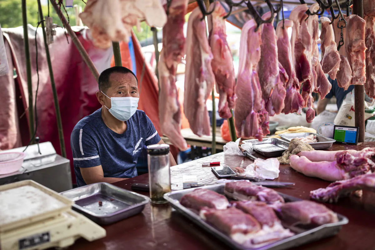 A vendor sells pork at an open market in Wuhan, China, on May 31, 2021. (Getty Images)
